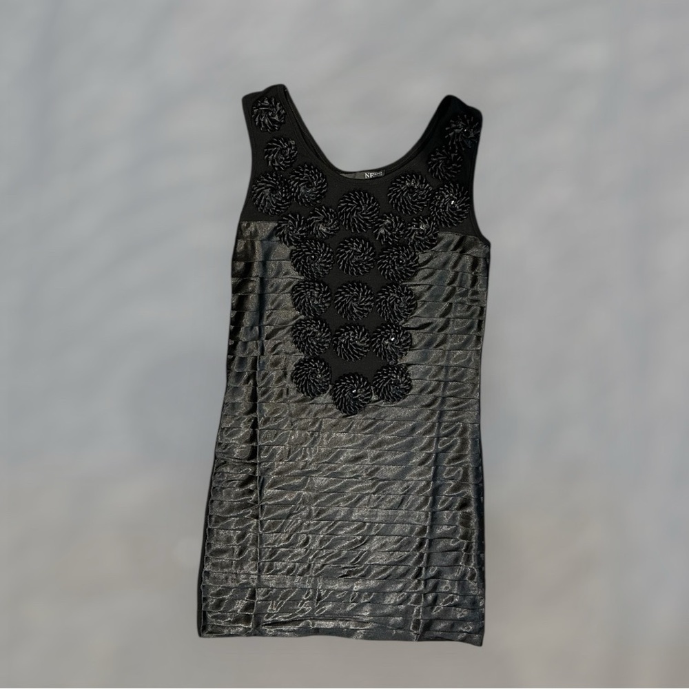 Ness Black Silk Dress with Flowers and Studes in the Middle

Size 34